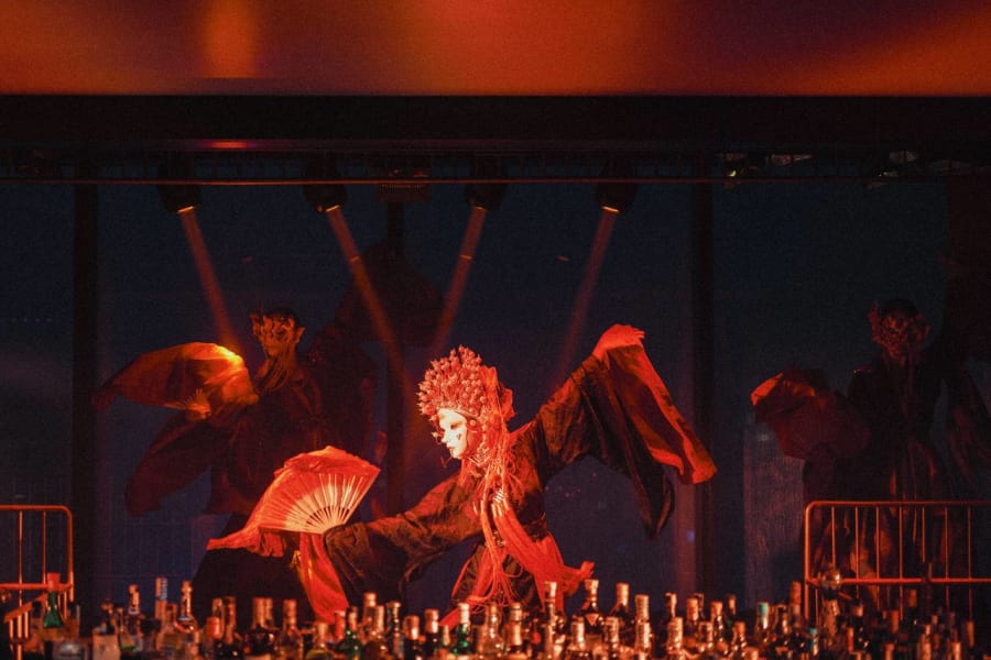 DẠ夜 IMPERIAL — performer with ornate headdress and red fan dancing dramatically