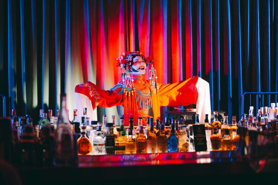DẠ夜 IMPERIAL — Chinese opera-inspired performer with outstretched arms behind the bar