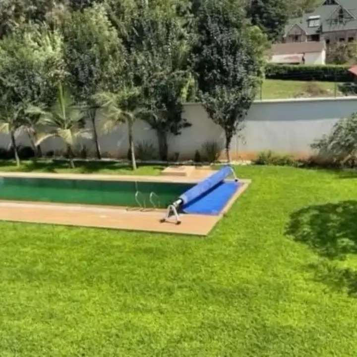 Landscaping team laying turf and preparing garden beds at a residential compound