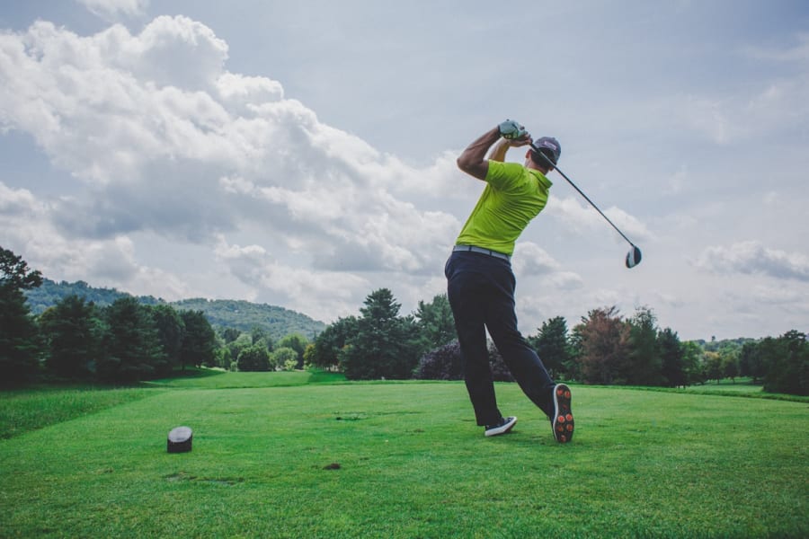 Golfer mid-swing on the course