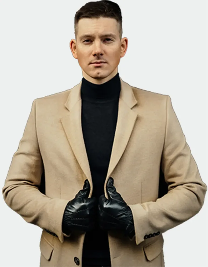 A man in a beige jacket and a black sweater