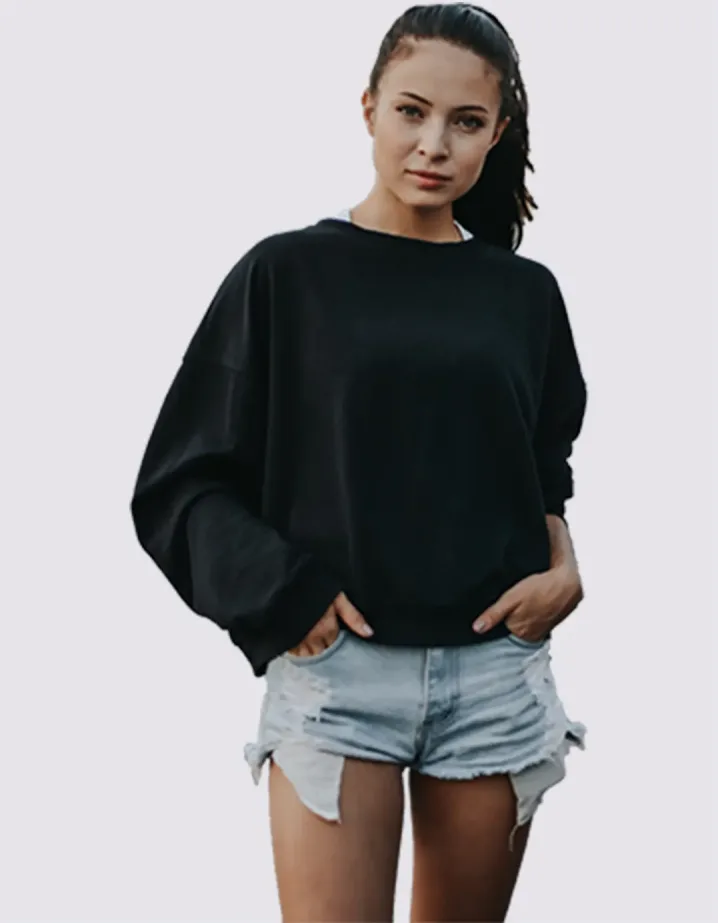 A girl in a black jacket and blue shorts