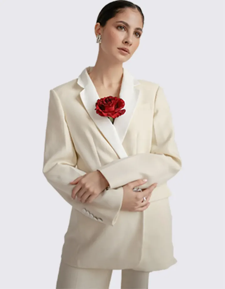 A girl in a white suit with a rose