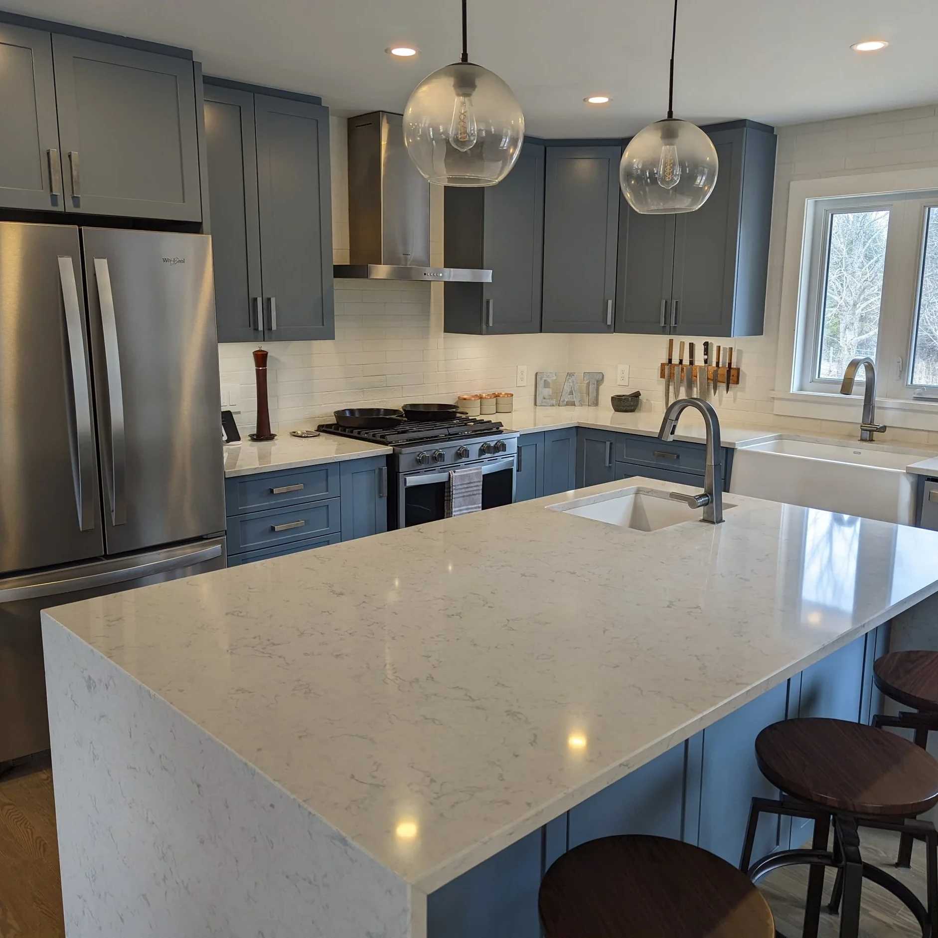 Modern farmhouse renovated kitchen with island, new appliances and quartz countertops