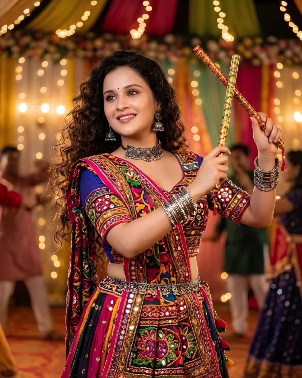 Curly Haired Woman in Multi-Color Mirror Work Chaniya Choli Crossing Dandiya Sticks