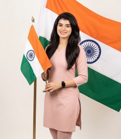 Elegant Woman in Pink Kurta Holding Indian Flag in Studio Portrait