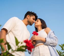 Low Angle Fashion Editorial Photograph of Couple Under Blue Sky