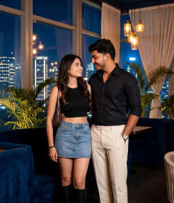 Stylish Couple Posing in Luxury Nighttime City Lounge Interior