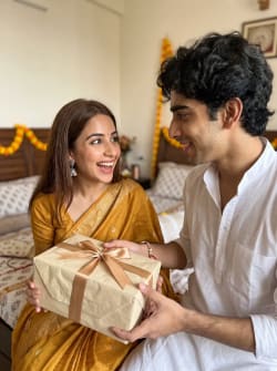 Indian Brother Presenting Raksha Bandhan Gift To Happy Sister Indoors