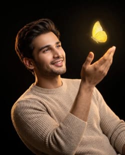 Cinematic Portrait of Man Reaching Toward Glowing Yellow Butterfly in Studio