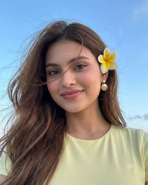 Low Angle Evening Selfie Portrait of Woman with Yellow Flower in Hair