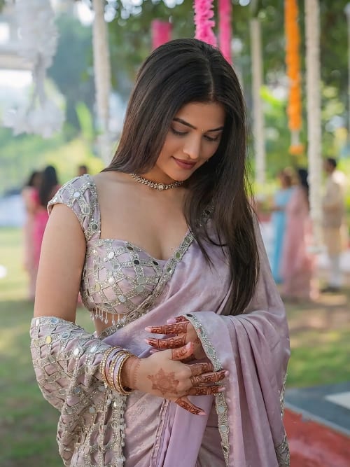 Young Woman in Dusty Mauve Mirror Work Saree with Henna Hands at Daytime Celebration