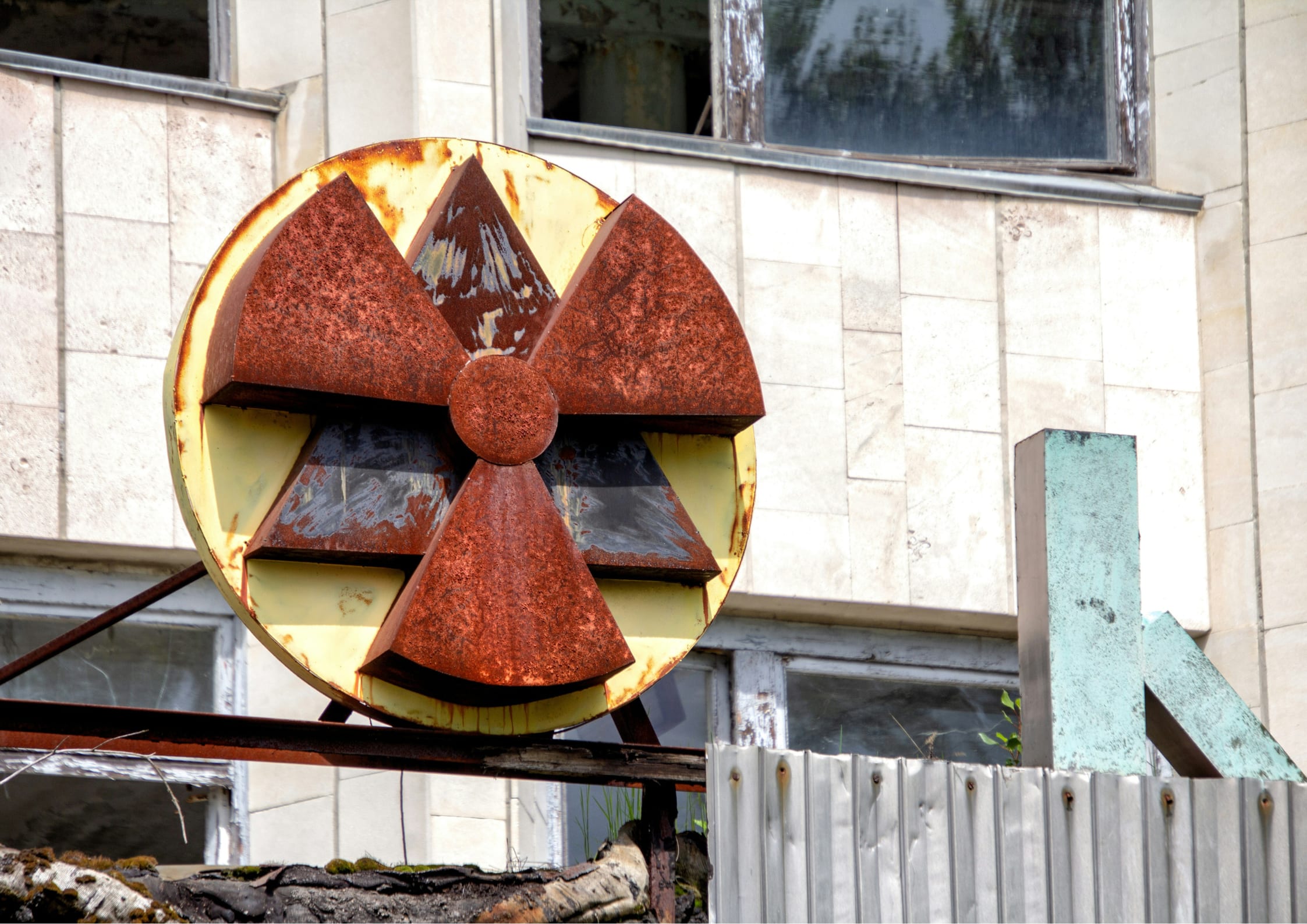 Rusted radioactive sign that is rusting and oxidized outside of a plant