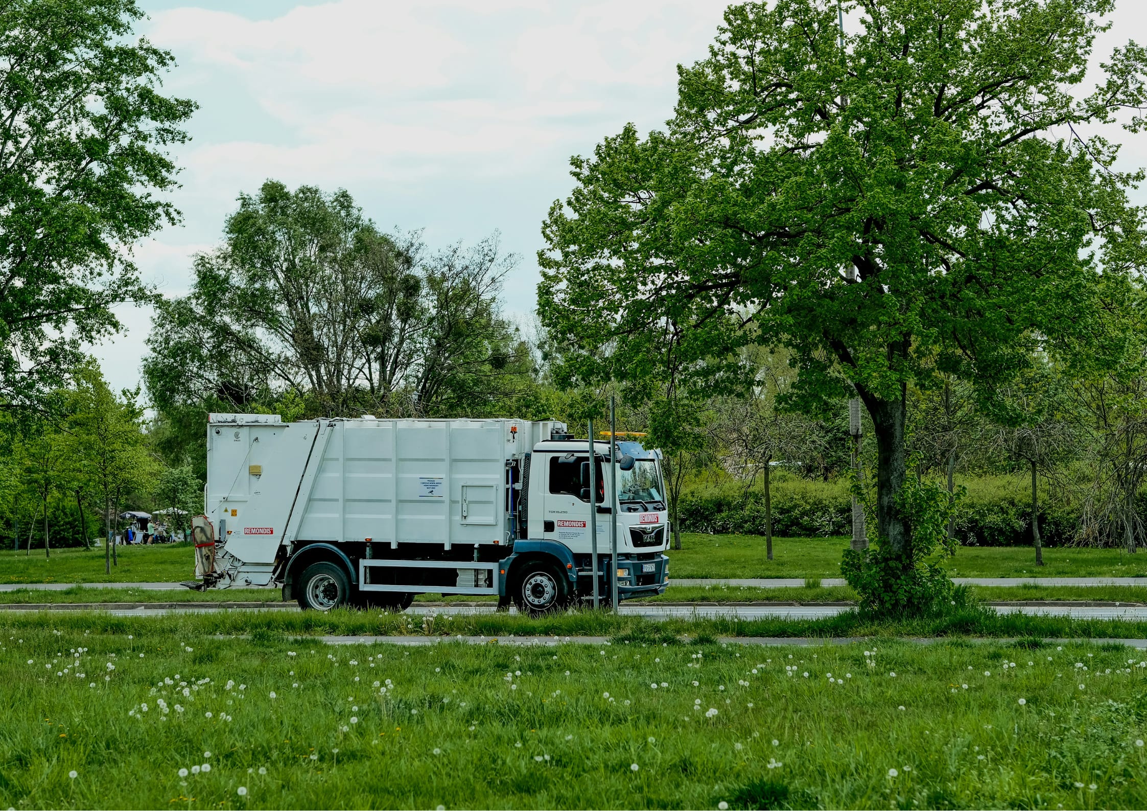 Trash truck outside getting properly disposed