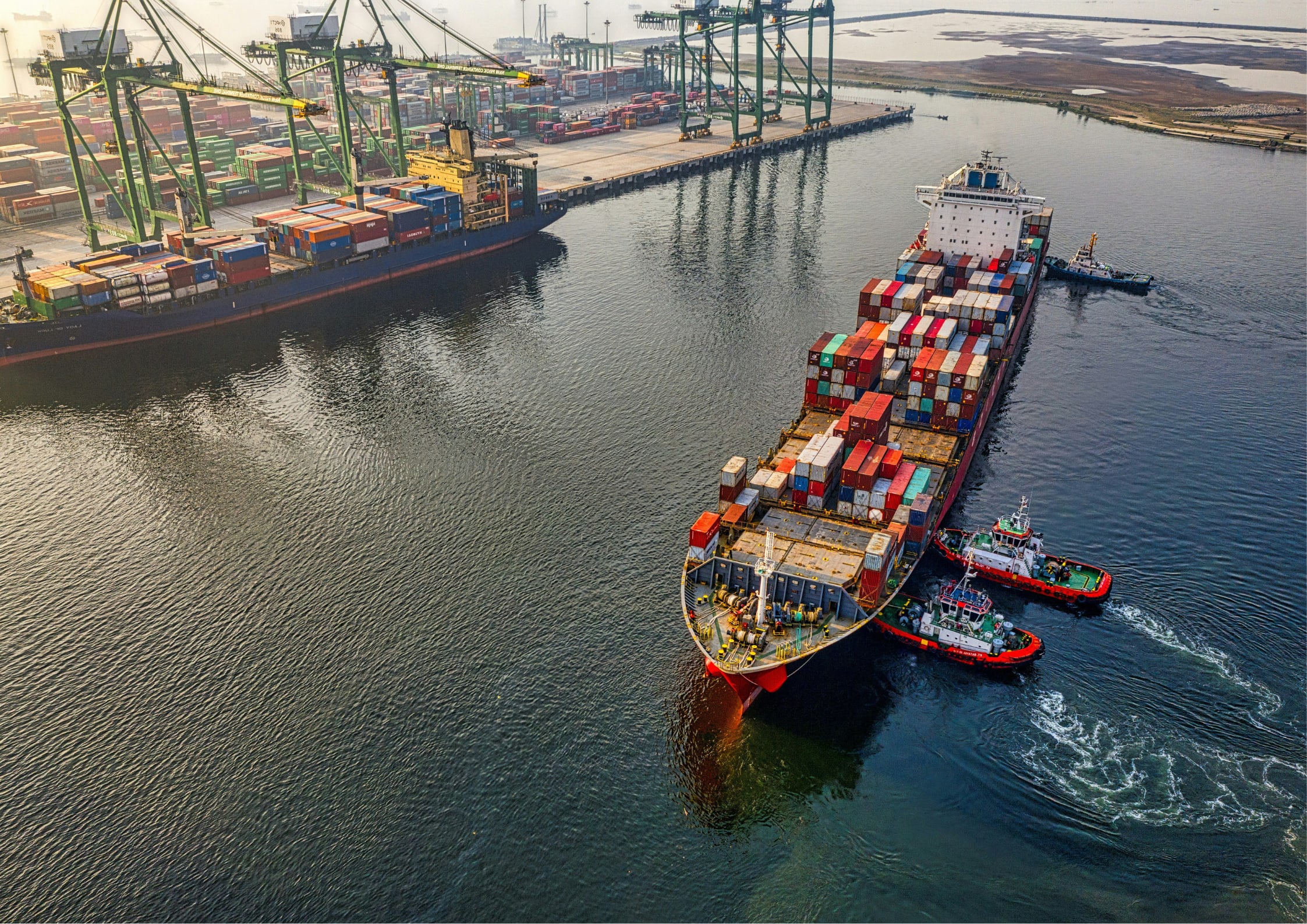 Shipping Container on the water in a port with disposed material