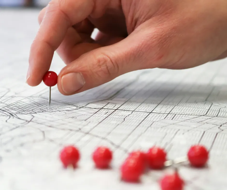 person puts location pin on a map