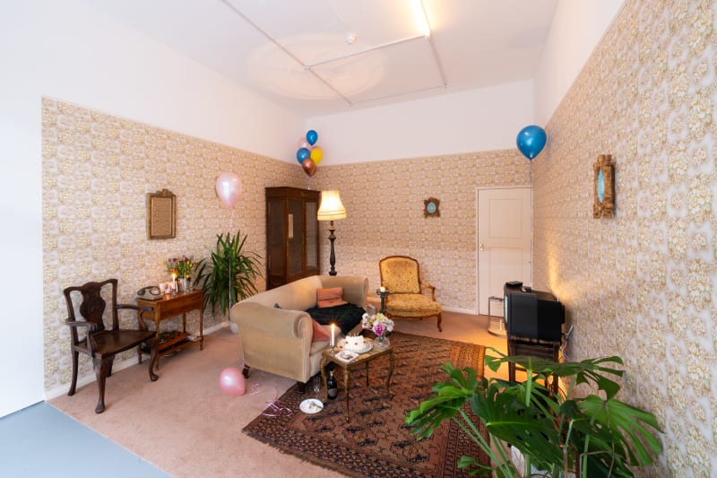 exhibition with a 1980s living room