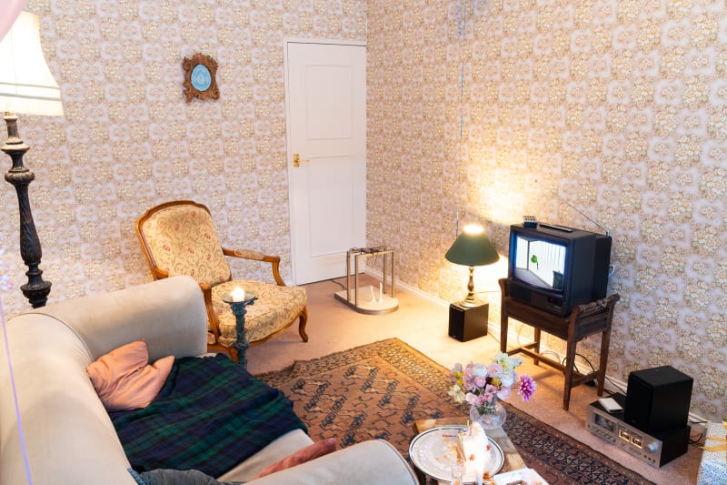 exhibition with a 1980s living room