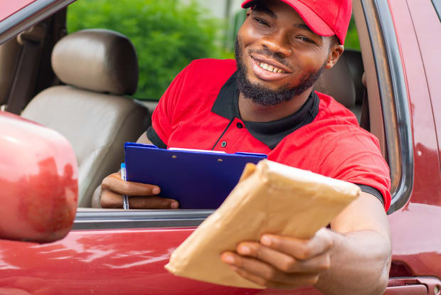 a delivery driver handing over a package