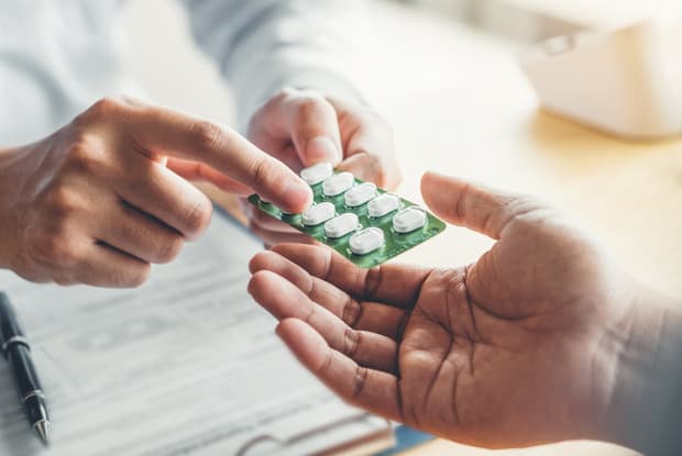 a doctor showing patient medication