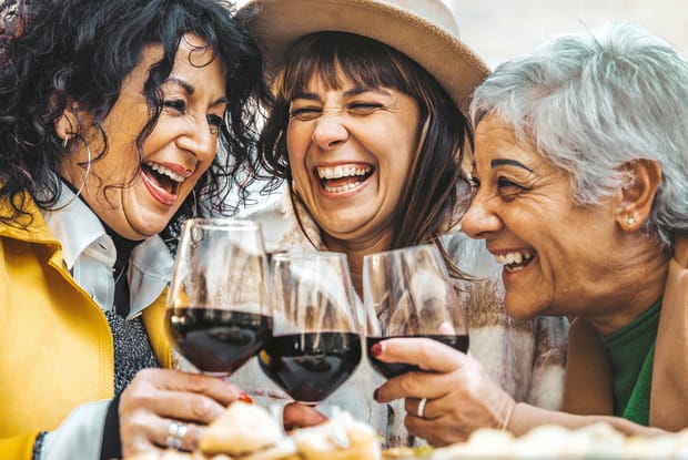 three women with glasses of wine