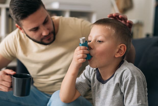 a child using an asthma inhaler