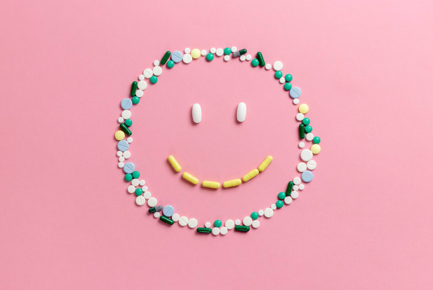 pills in smile shape on a pink background