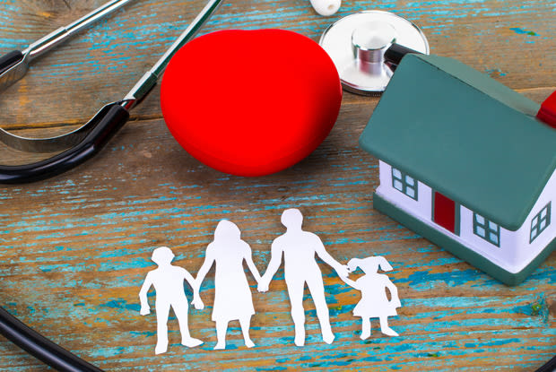 a cutout family around house and medical equipment 