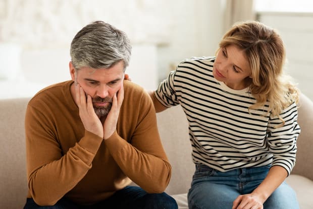 a man being consoled by woman