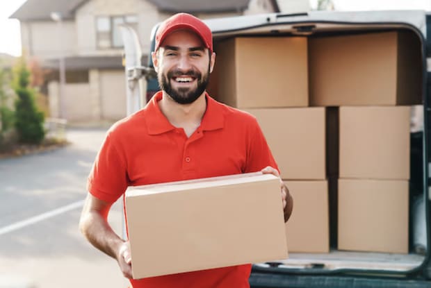 a man in red holding a parcel