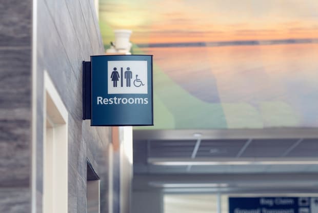 a washroom sign at an airport terminal