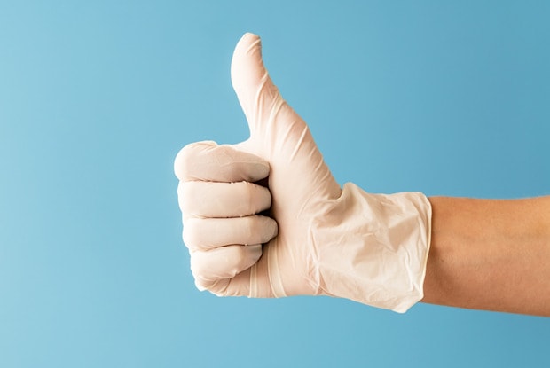 gloved hand giving a thumbs up