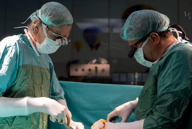 two surgeons working on a patient