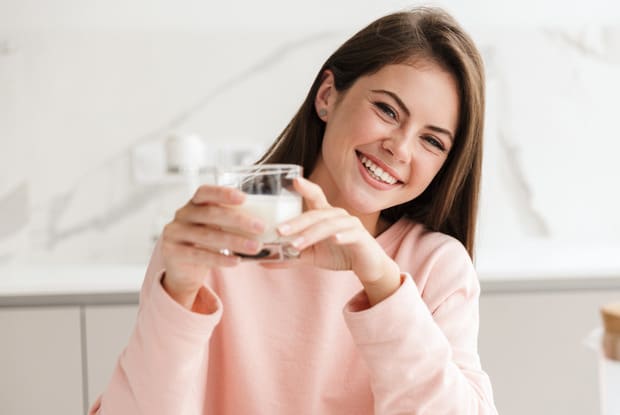 a woman drinking a glass of milk