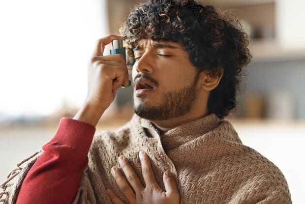 a man using an inhaler