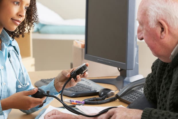 man getting their blood pressure read