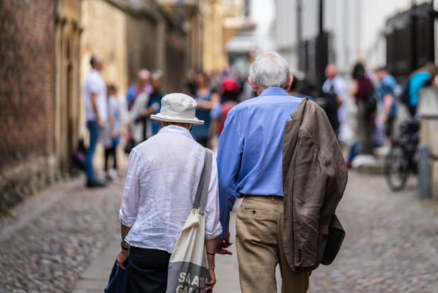 two older people walking down the street