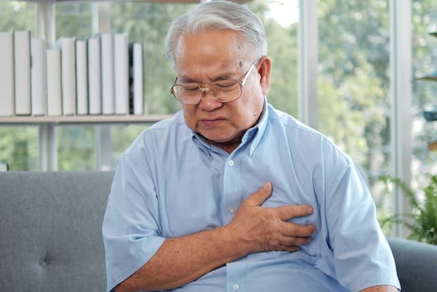 a man clutching his chest area