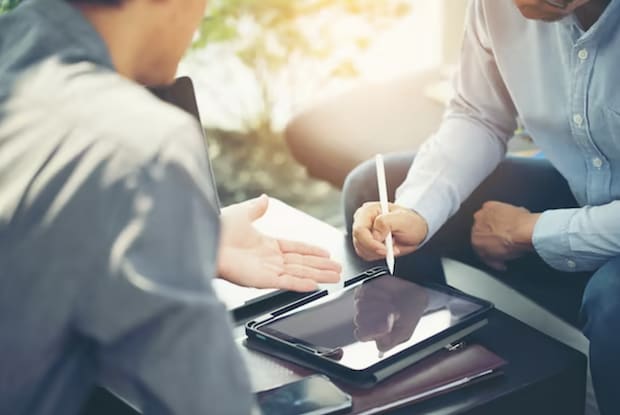 two people discussing things with a tablet