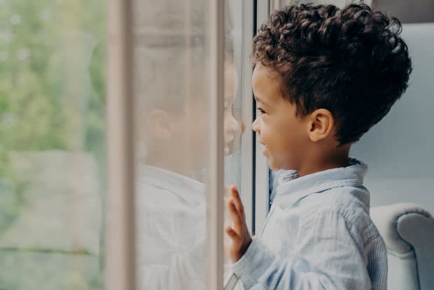 a toddler looking out a window