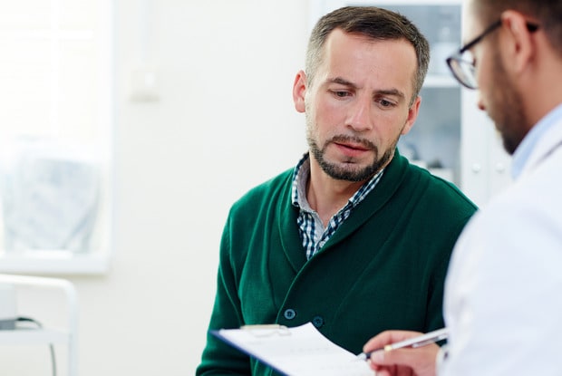 a man talking to a doctor