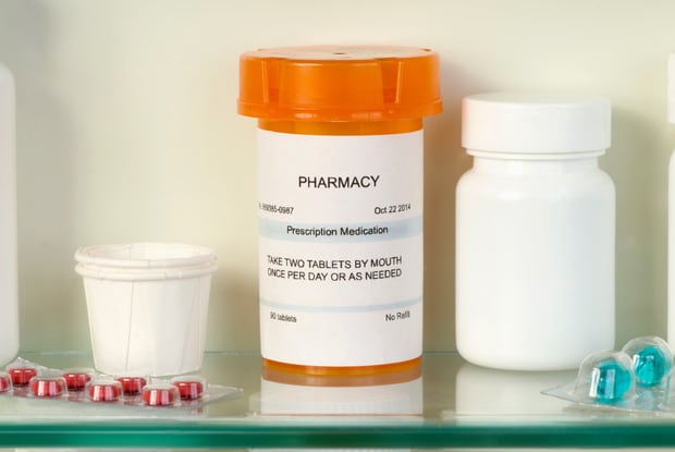 generic pill bottle in a medication cabinet