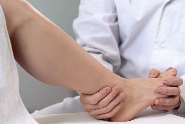 a doctor assessing a patient’s leg