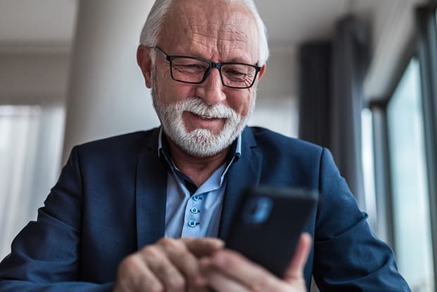 an older person looking at a phone