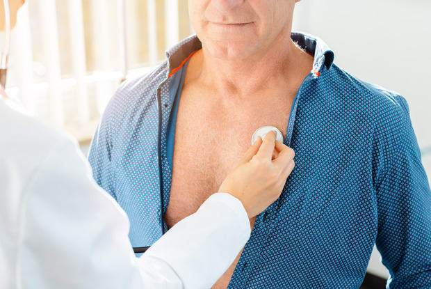 a doctor checking the lung function of a patient