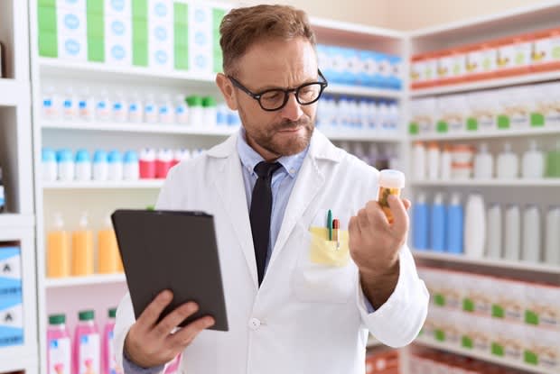 a pharmacist reading the label of a drug