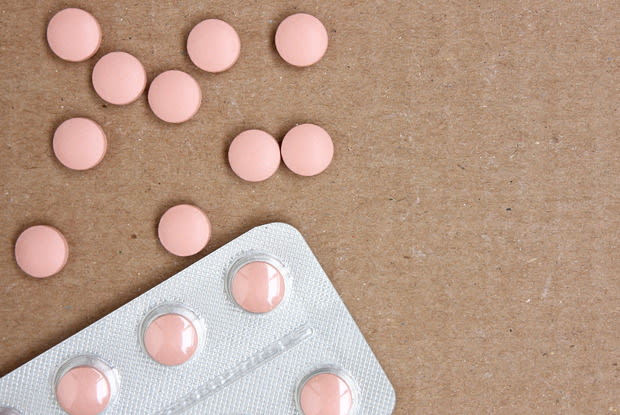 pink pills in and around a blister pack