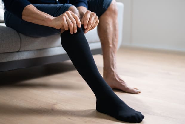 man wearing compression sock