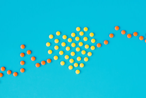 pills in shape of heart electrocardiogram