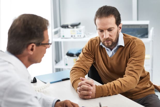 a doctor speaking to his patient